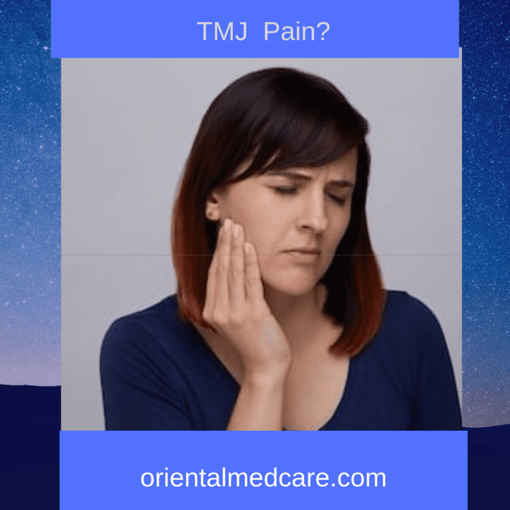 Woman holding jaw due to TMJ pain—acupuncture for TMJ relief in Edina MN