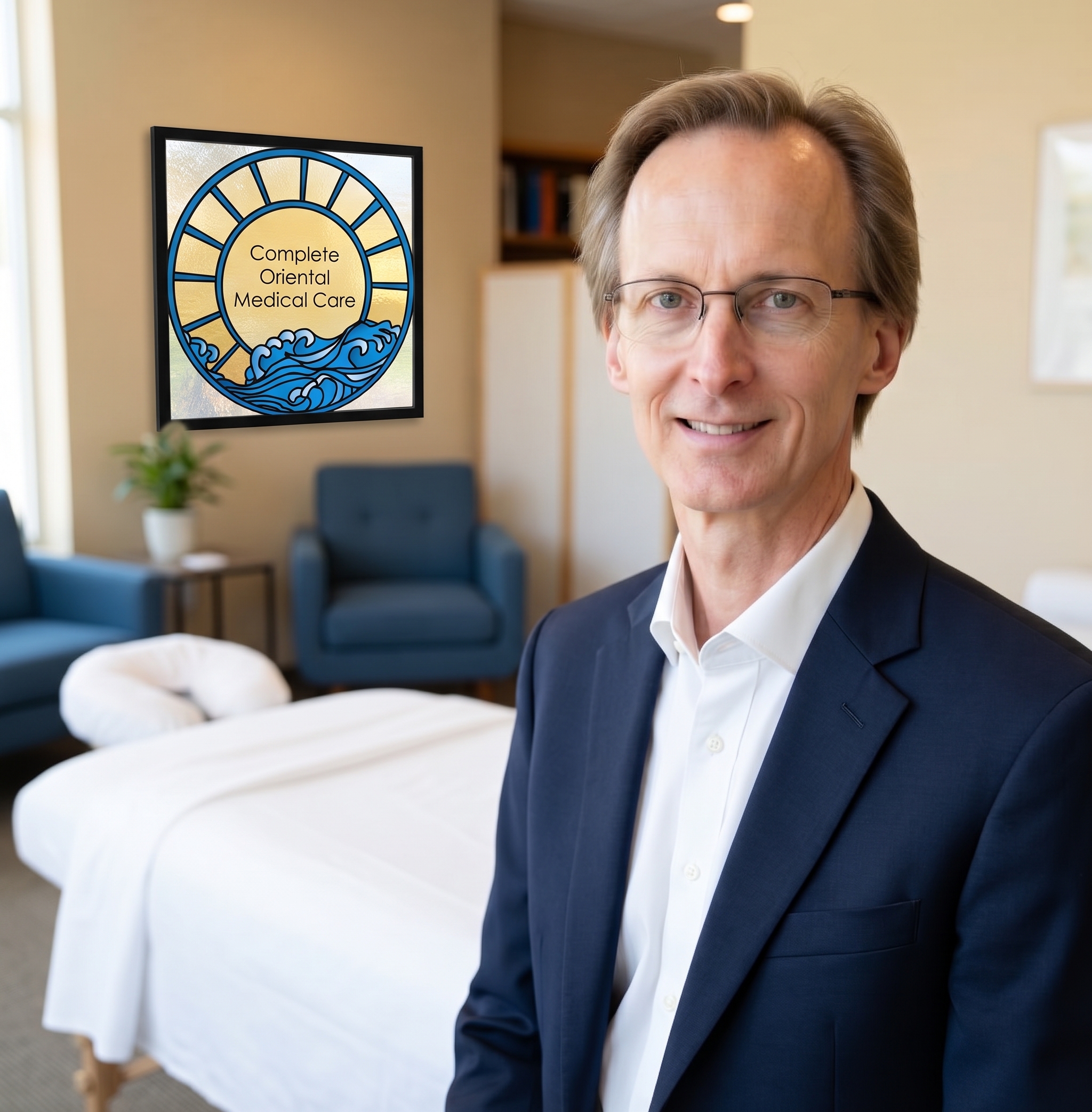 Steven Sonmore, L.Ac., of Complete Oriental Medical Care in Edina, MN, stands with his clinic’s stained-glass logo.