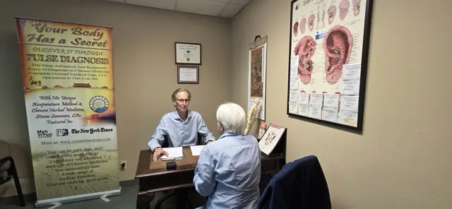 Steven Sonmore discussing treatment recommendations with a patient
