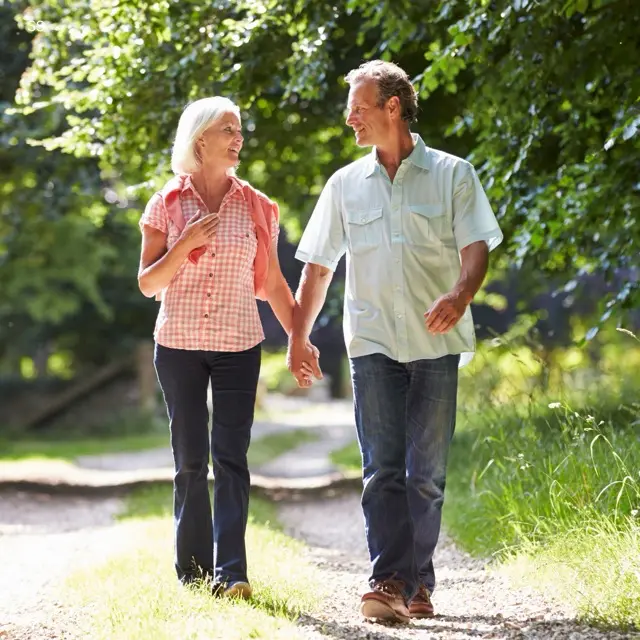 Older couple walking together outdoors