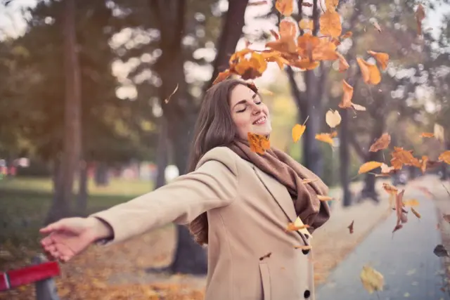 Woman outdoors enjoying energy, vitality, and well-being